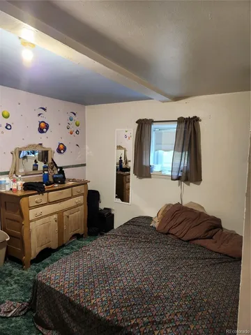 a bedroom with a bed and a table in it