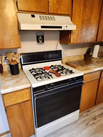 a stove top oven sitting inside of a kitchen