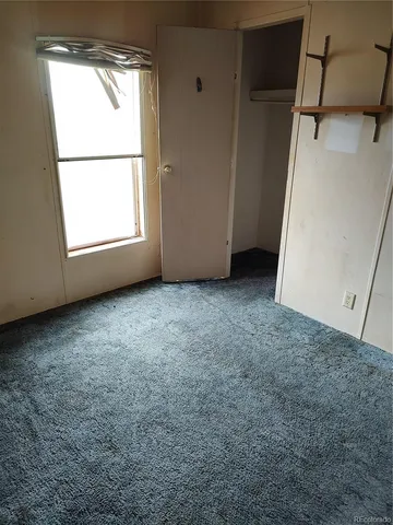 a bathroom with a granite countertop toilet a sink and a shower