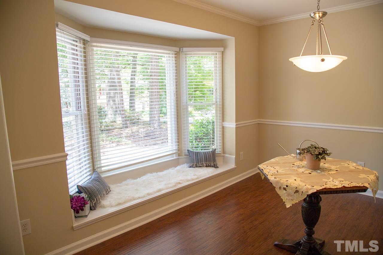 5613 Hamstead Crossing Raleigh, NC 27612 - Photo 2 of 20 a view of a room with a window and wooden floor