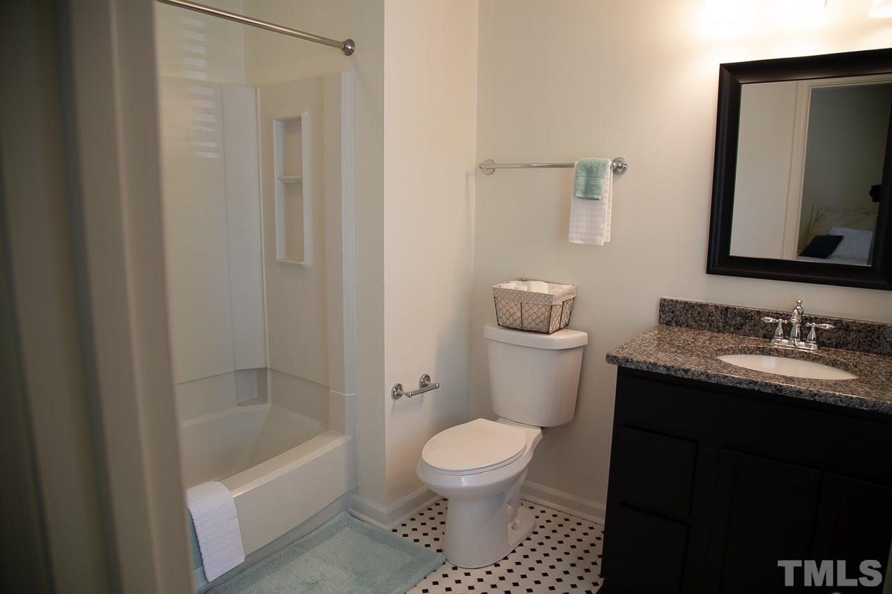 5613 Hamstead Crossing Raleigh, NC 27612 - Photo 15 of 20 a bathroom with a granite countertop sink toilet and shower