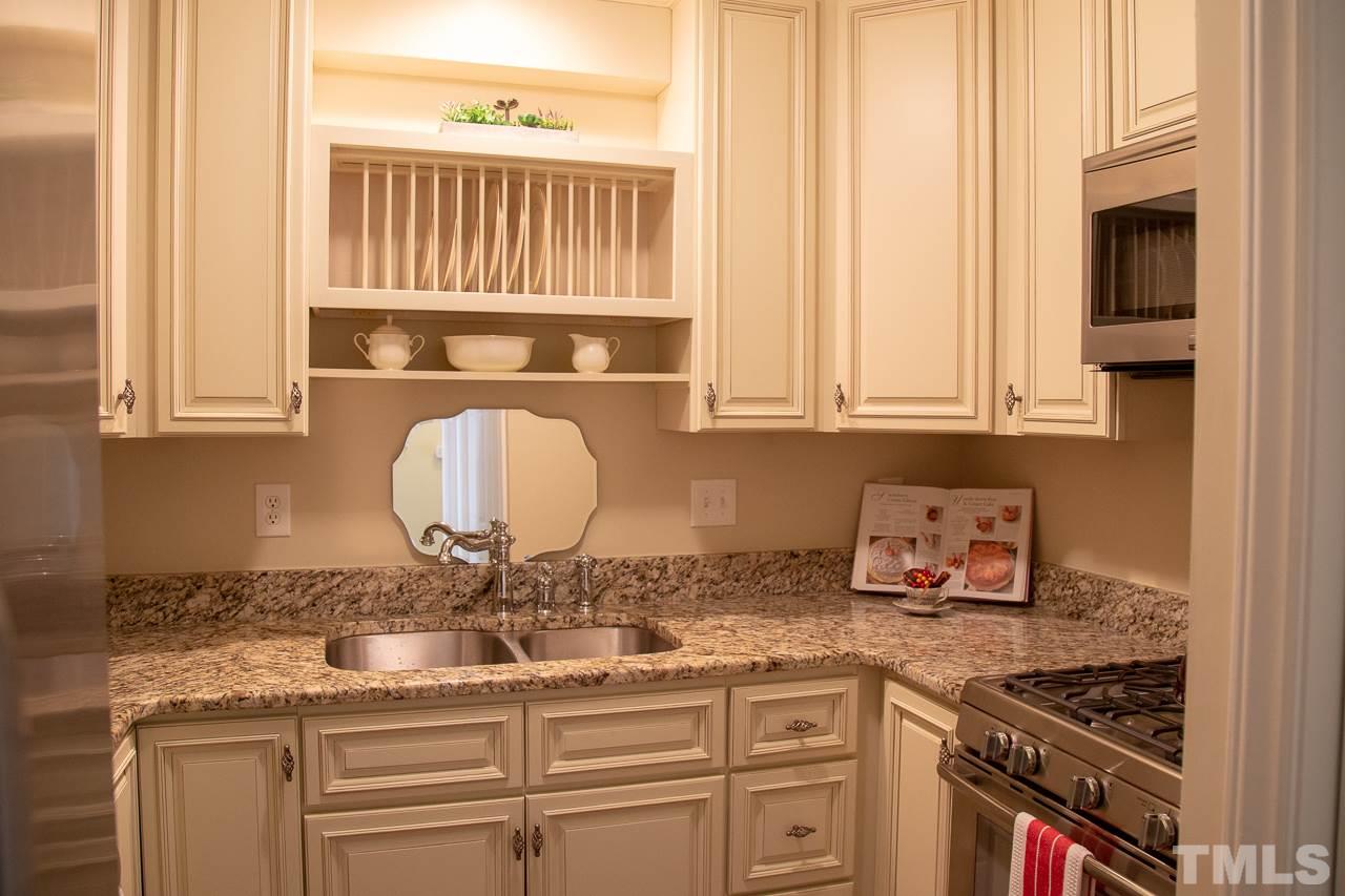 5613 Hamstead Crossing Raleigh, NC 27612 - Photo 7 of 20 a kitchen with granite countertop a sink and a stove