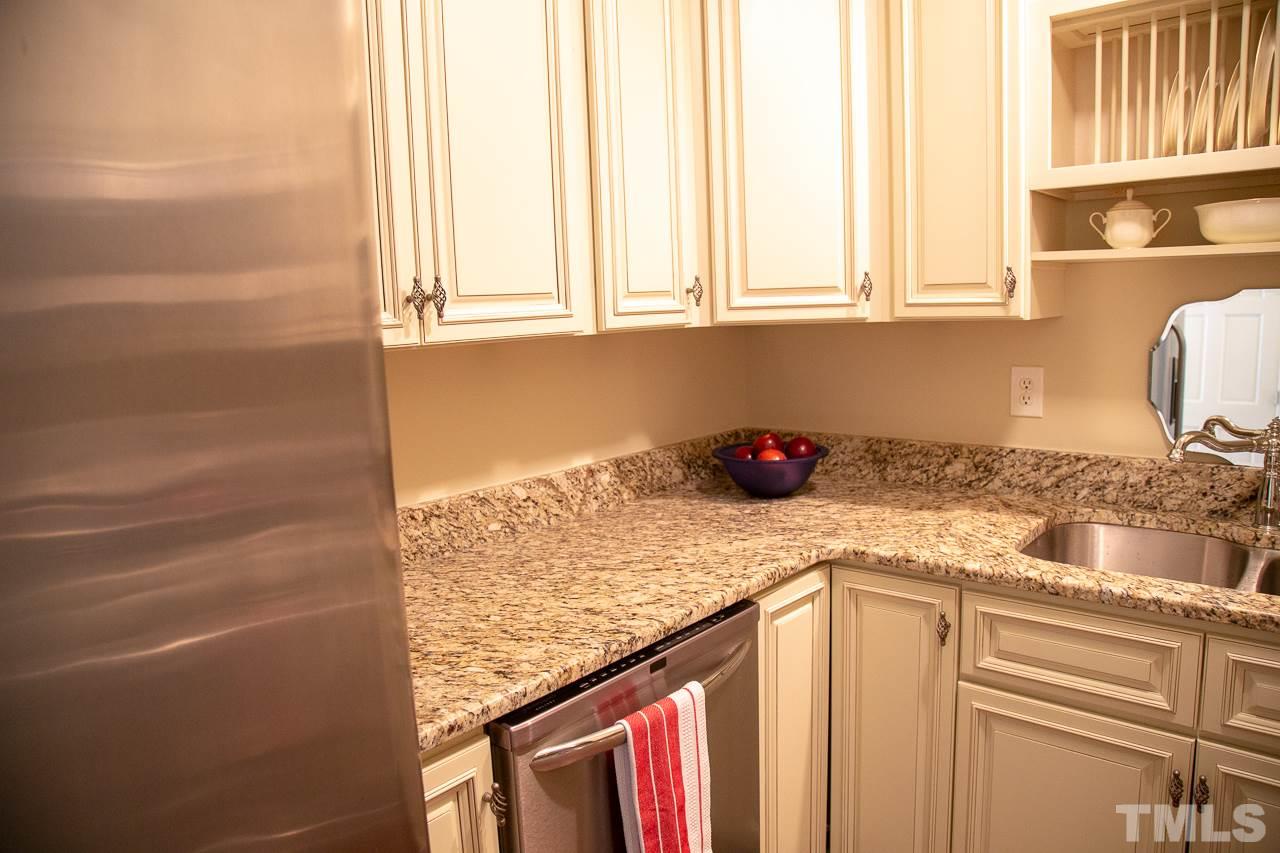 5613 Hamstead Crossing Raleigh, NC 27612 - Photo 9 of 20 a kitchen with stainless steel appliances granite countertop a sink and a window