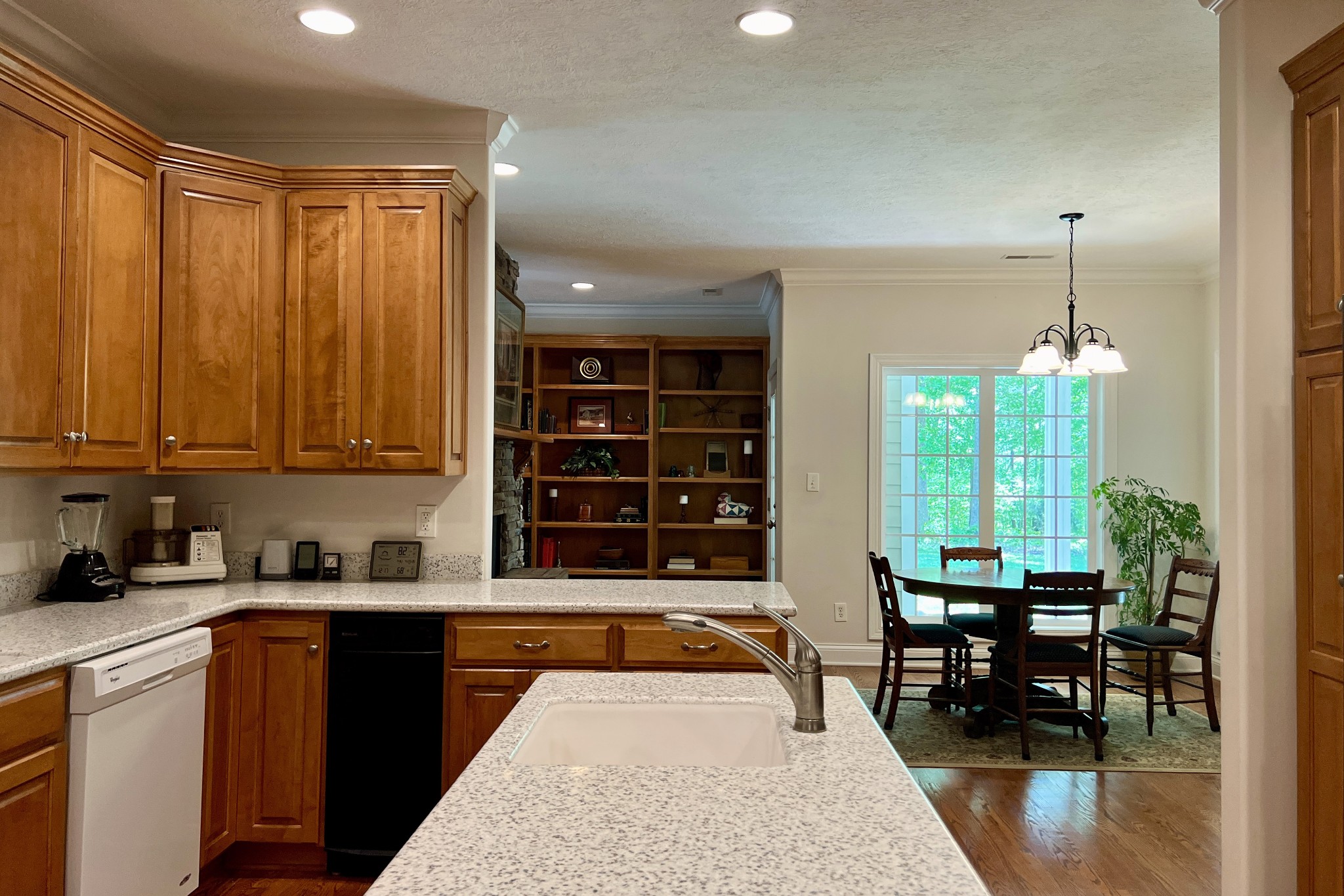 1371 Johns Loop Road Franklin, KY 42134 - Photo 12 of 72 a kitchen with granite countertop a stove a sink a dining table and chairs with wooden floor
