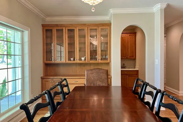 a kitchen with stainless steel appliances granite countertop a refrigerator a stove top oven and sink