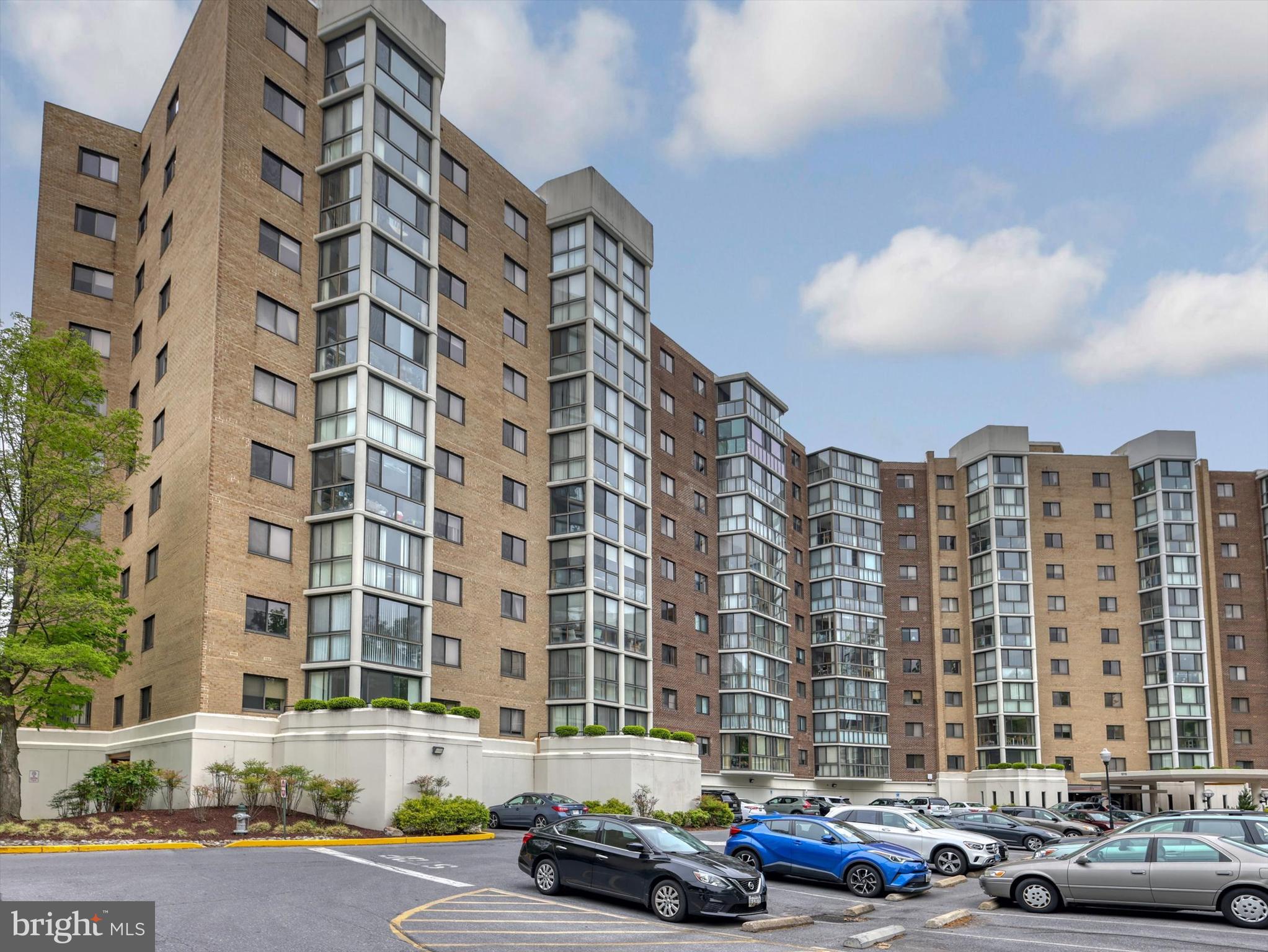 15115 Interlachen Drive, Unit 31012 Silver Spring, MD 20906 - Photo 1 of 35 a cars parked in front of a tall building