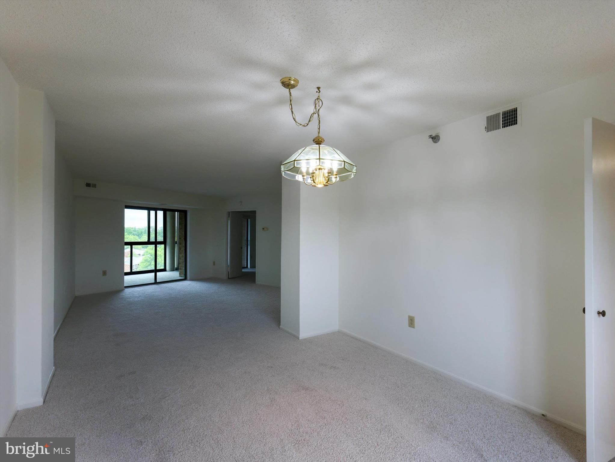 15115 Interlachen Drive, Unit 31012 Silver Spring, MD 20906 - Photo 12 of 35 a view of a chandelier fan and windows in a room