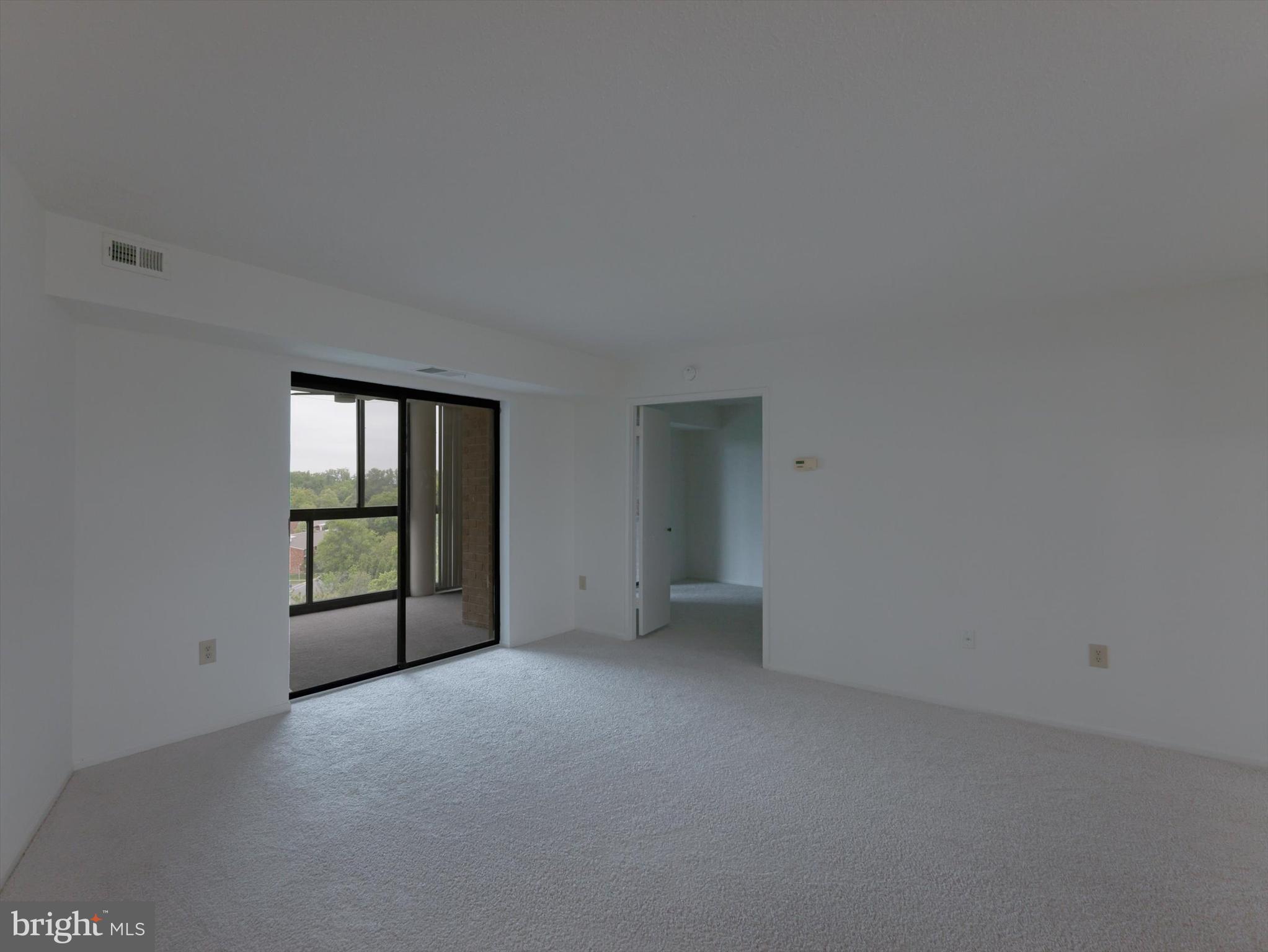 15115 Interlachen Drive, Unit 31012 Silver Spring, MD 20906 - Photo 14 of 35 a view of an empty room with a window