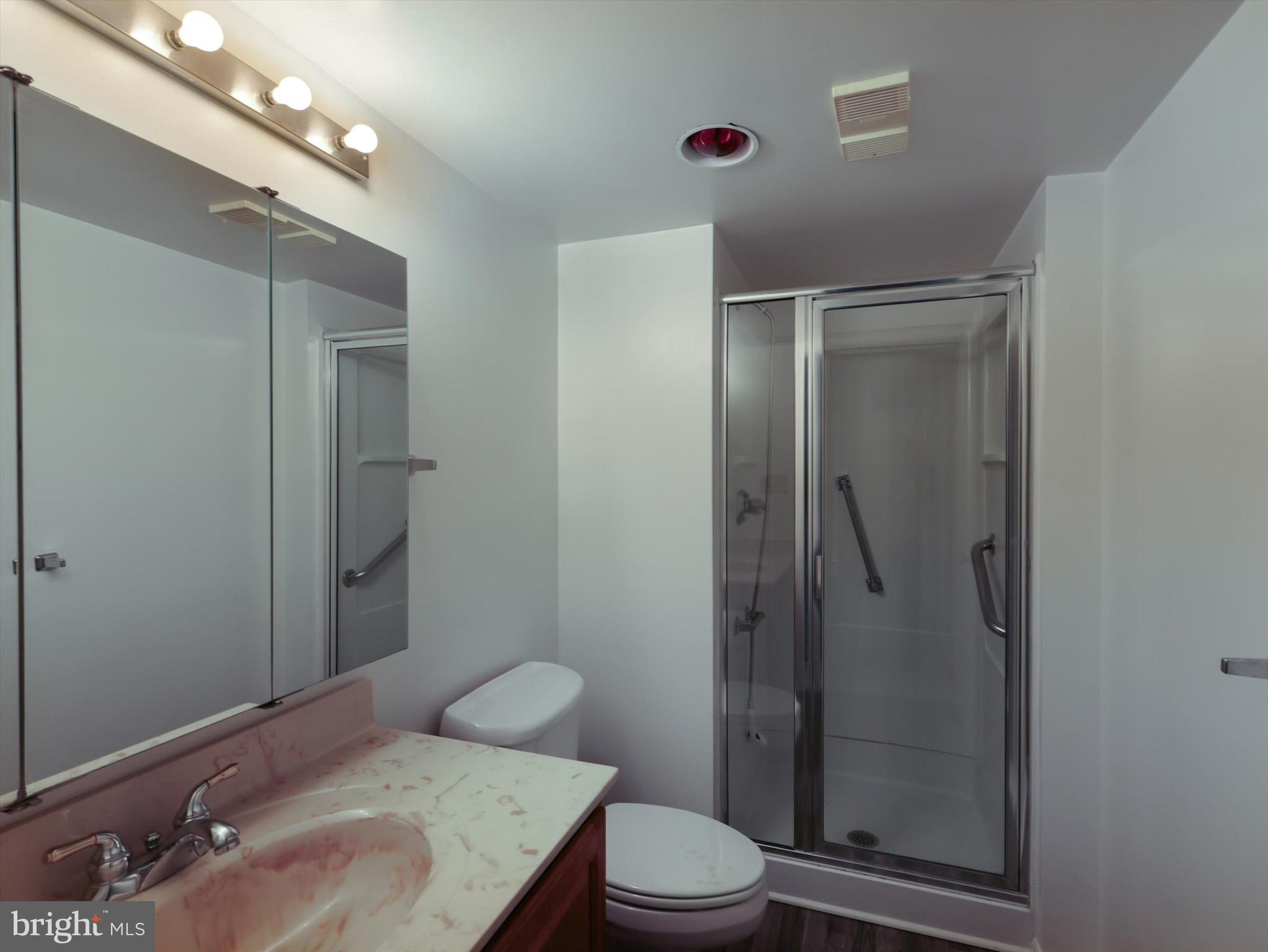 15115 Interlachen Drive, Unit 31012 Silver Spring, MD 20906 - Photo 17 of 35 a bathroom with a toilet a sink and shower