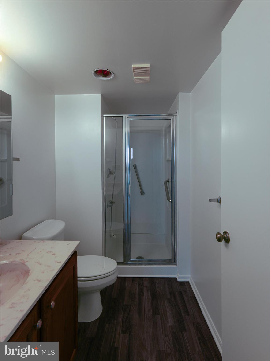 15115 Interlachen Drive, Unit 31012 Silver Spring, MD 20906 - Photo 18 of 35 a bathroom with a granite countertop sink toilet and shower