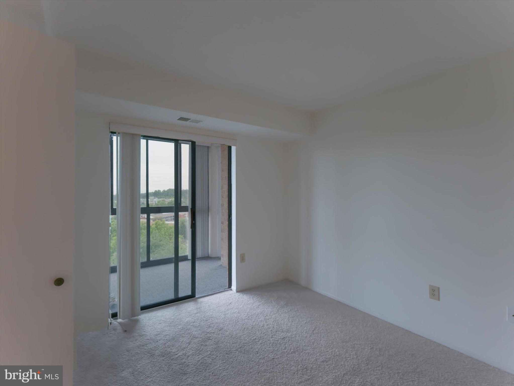 15115 Interlachen Drive, Unit 31012 Silver Spring, MD 20906 - Photo 21 of 35 a view of an empty room with glass door