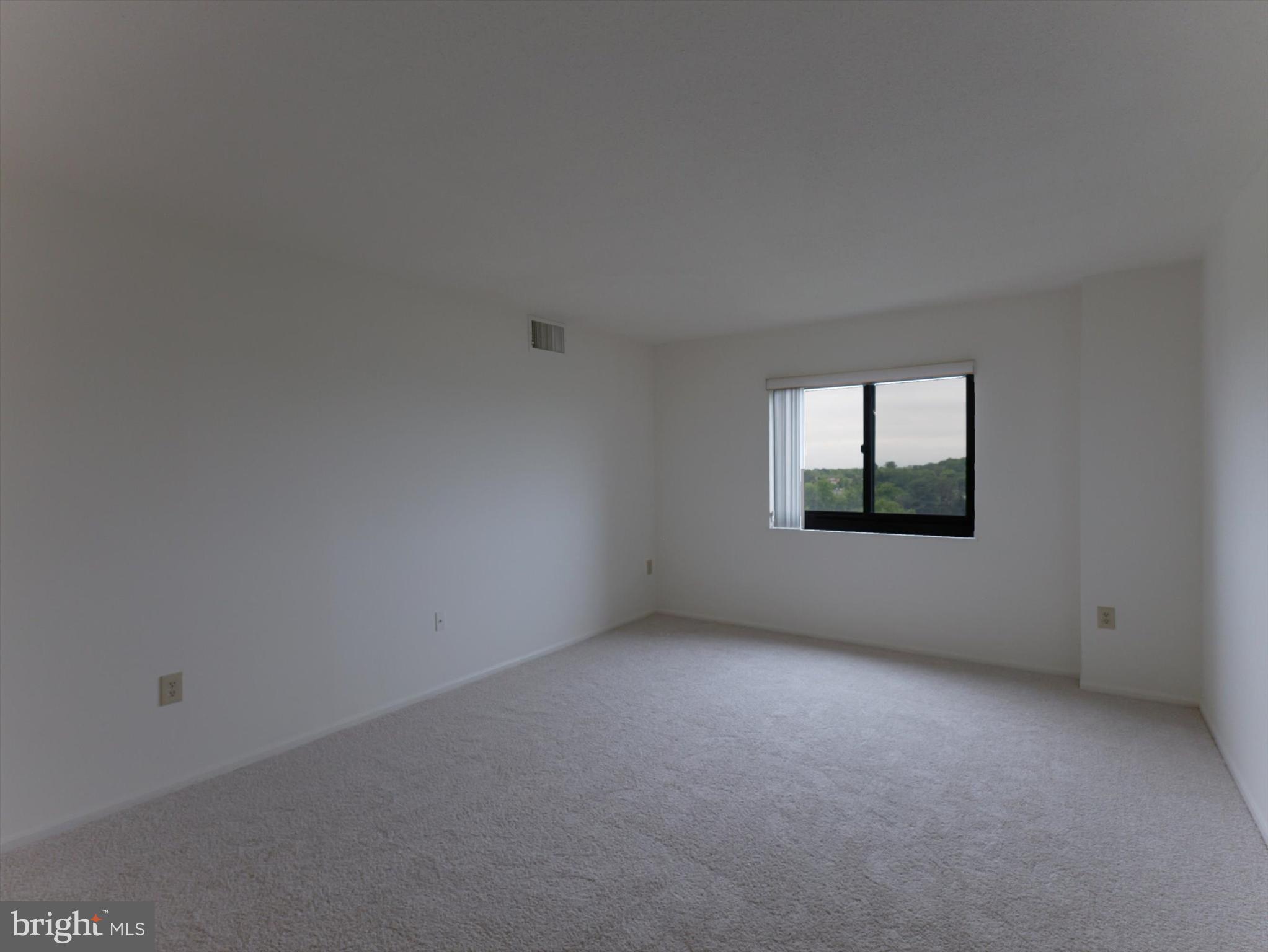 15115 Interlachen Drive, Unit 31012 Silver Spring, MD 20906 - Photo 30 of 35 a view of an empty room with a window