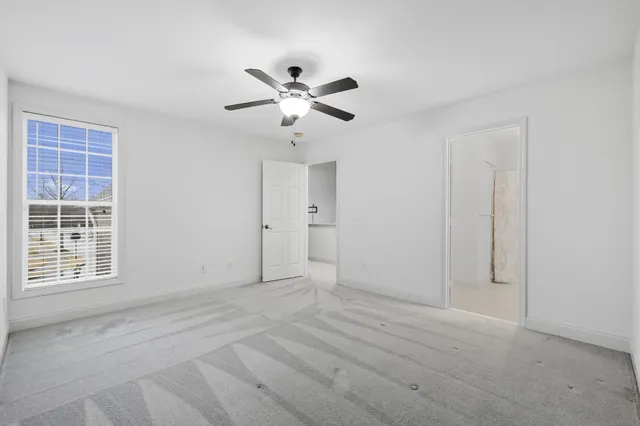 a view of empty room with ceiling fan