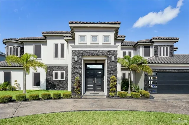 a view of a house with a small yard and plants