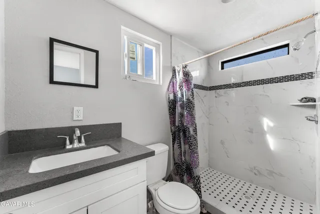 a view of a house with a snow in the background