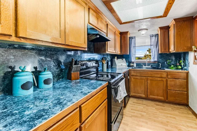a kitchen with sink and cabinets