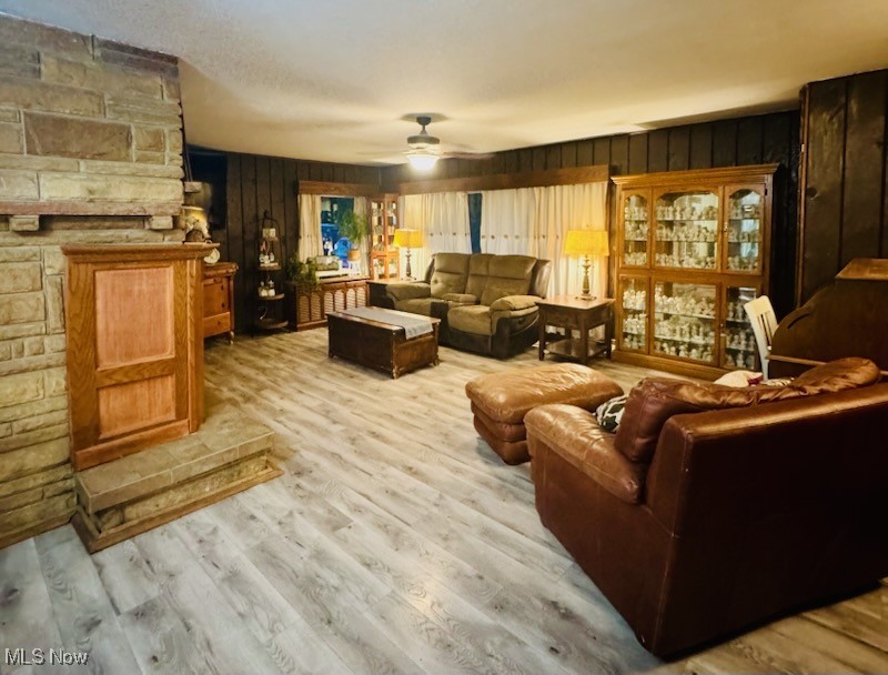 2675 Seifert-Lewis Road Hubbard, OH 44425 - Photo 3 of 38 Living area featuring light wood finished floors, ceiling fan, and wood walls