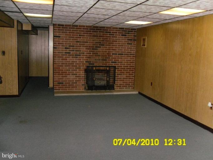8003 Haas Lane Rosedale, MD 21237 - Photo 13 of 18 LL family room with fireplace and plenty of lights