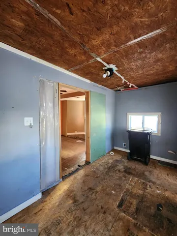 a view of an empty room with wooden walls
