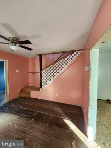 a view of a room with wooden floor