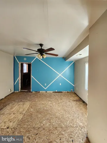 a view of a hallway with wooden floor and stairs