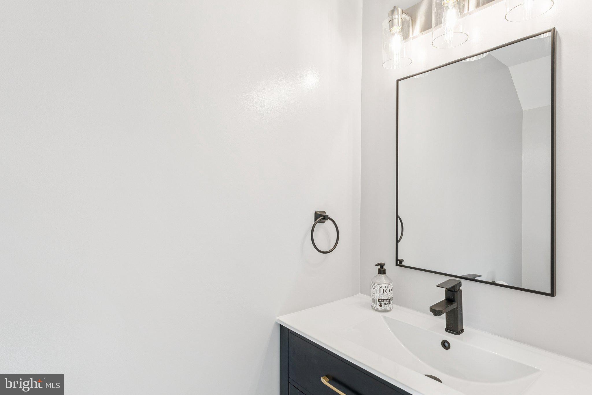 7408 Emerald Drive Manassas, VA 20109 - Photo 12 of 44 a bathroom with a sink and mirror