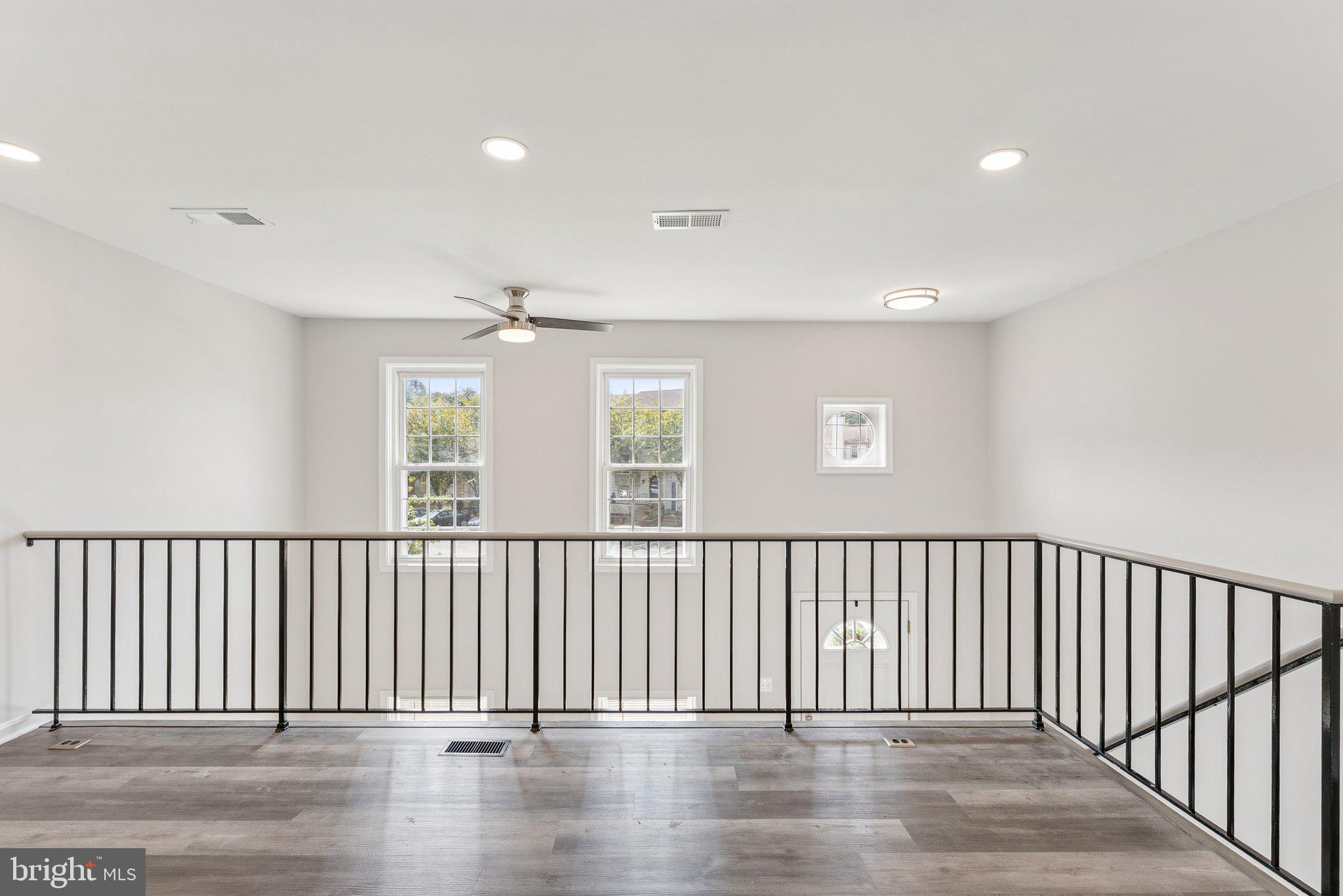 7408 Emerald Drive Manassas, VA 20109 - Photo 16 of 44 an empty room with wooden floor and windows