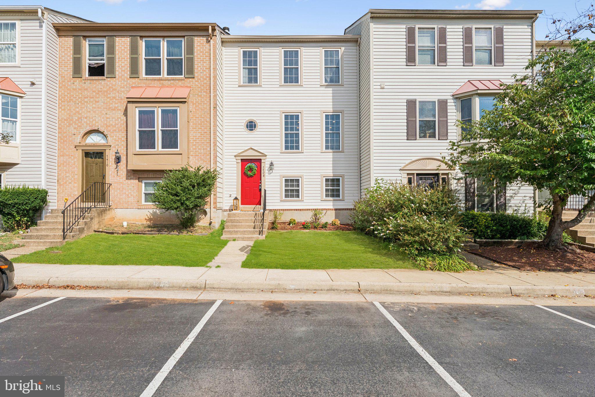 7408 Emerald Drive Manassas, VA 20109 - Photo 2 of 44 a front view of a house with a yard and a garage