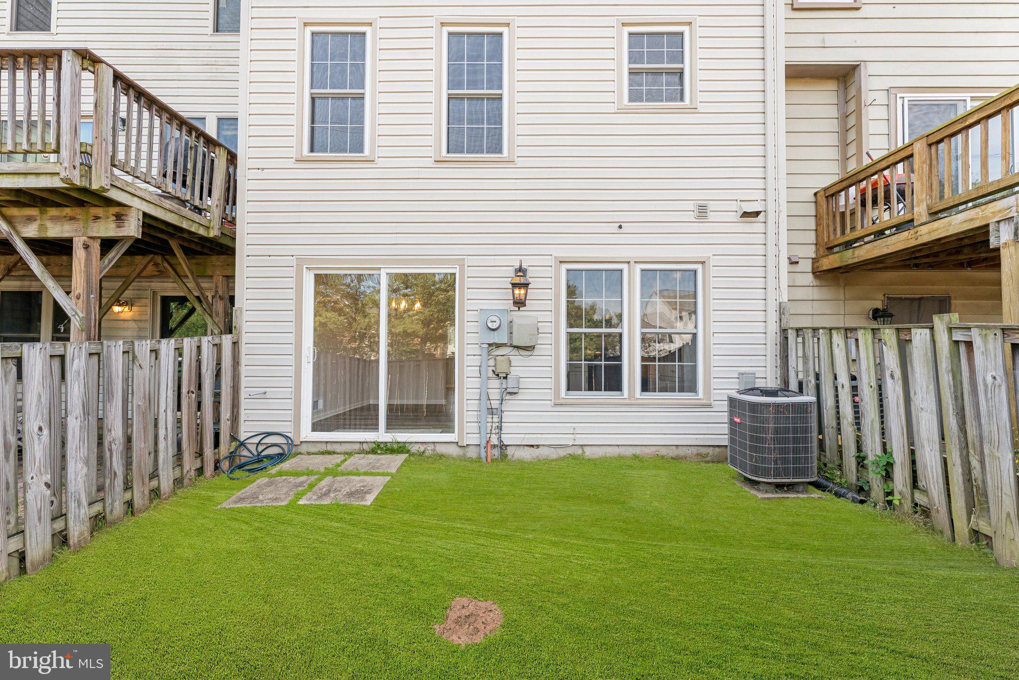 7408 Emerald Drive Manassas, VA 20109 - Photo 33 of 44 a front view of a house with a garden