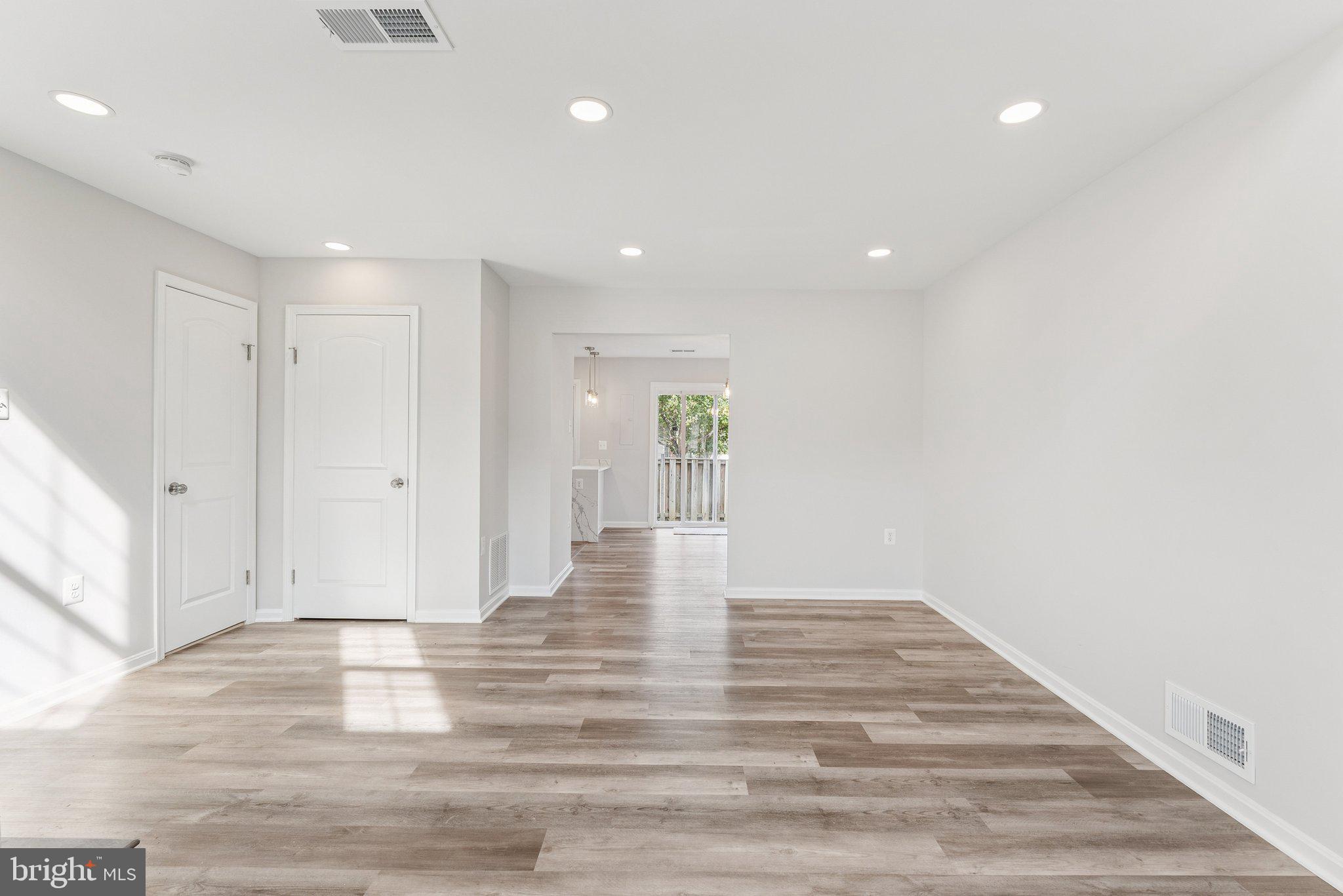 7408 Emerald Drive Manassas, VA 20109 - Photo 6 of 44 a view of an empty room with wooden floor