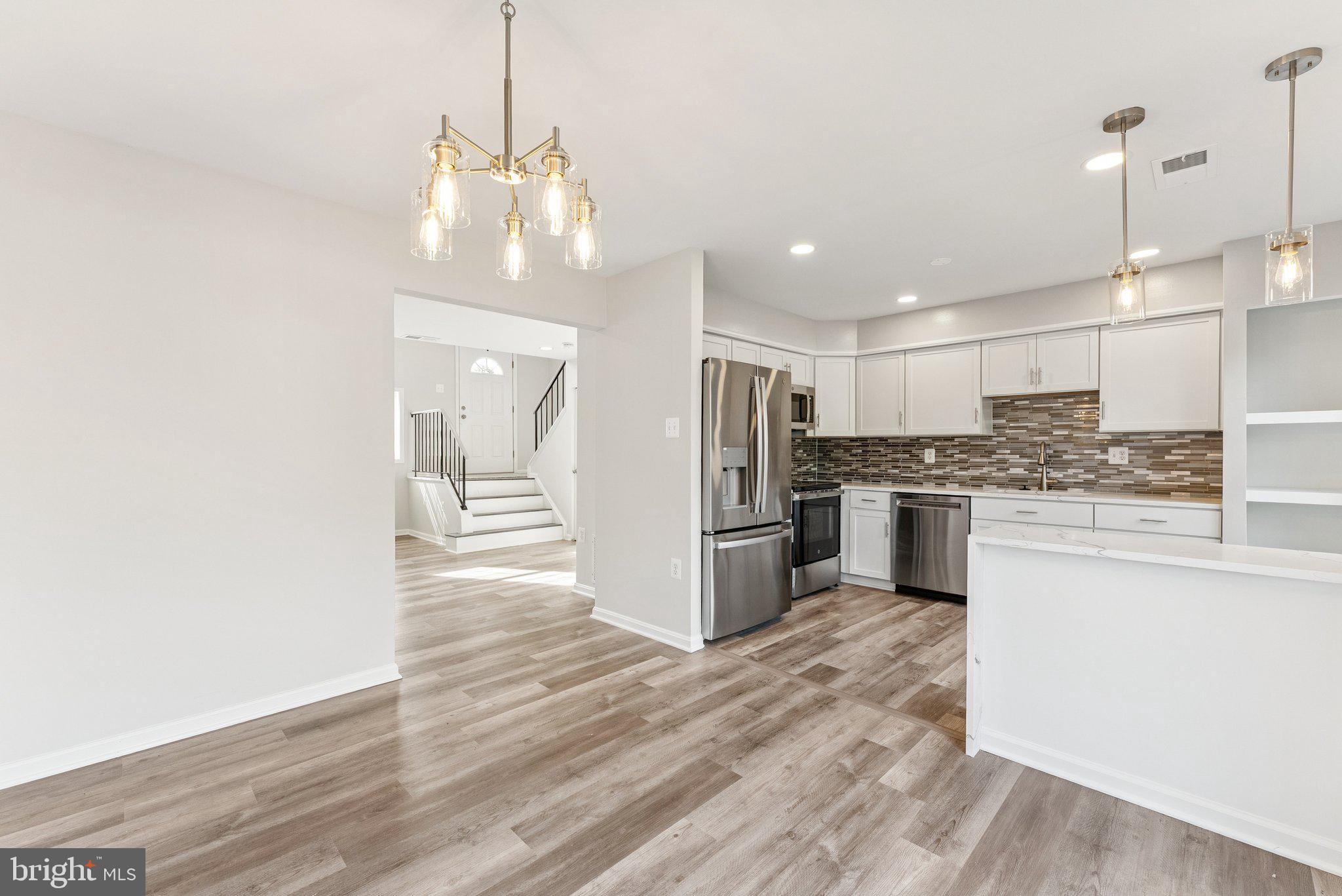 7408 Emerald Drive Manassas, VA 20109 - Photo 8 of 44 a kitchen with stainless steel appliances a refrigerator sink and stove