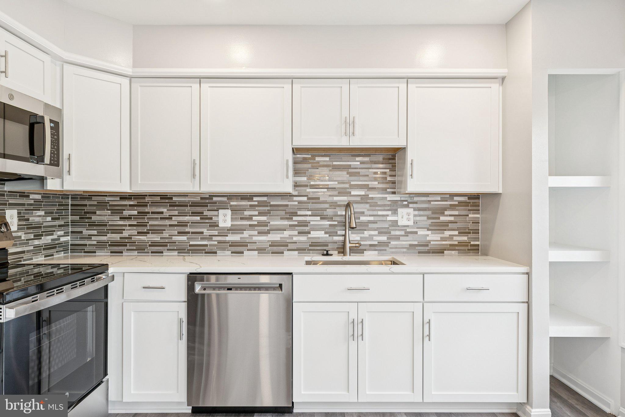 7408 Emerald Drive Manassas, VA 20109 - Photo 9 of 44 a kitchen with stainless steel appliances white cabinets and a sink