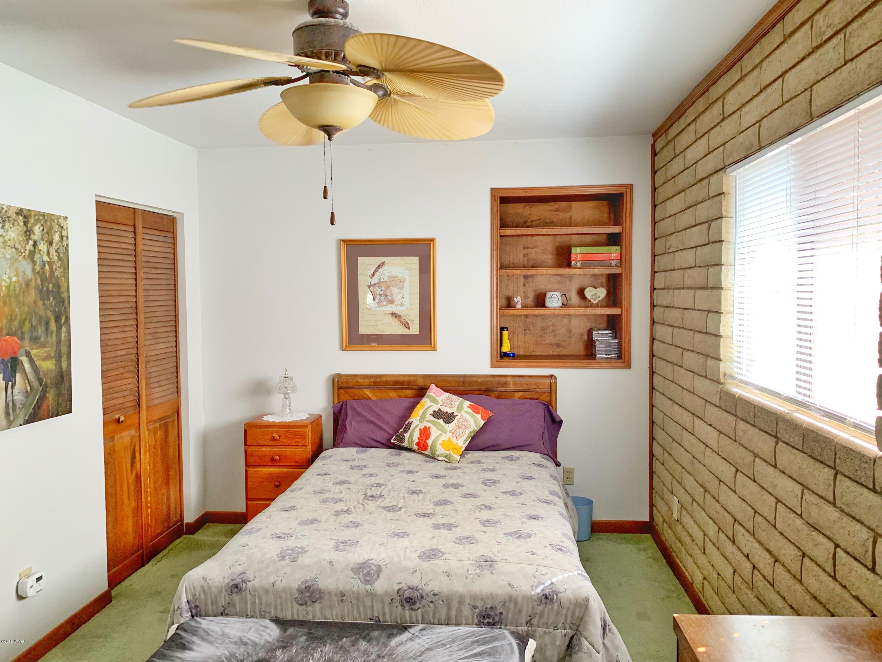 2128 Cottontail Road Overgaard, AZ 85933 - Photo 12 of 18 a bedroom with a bed and a window