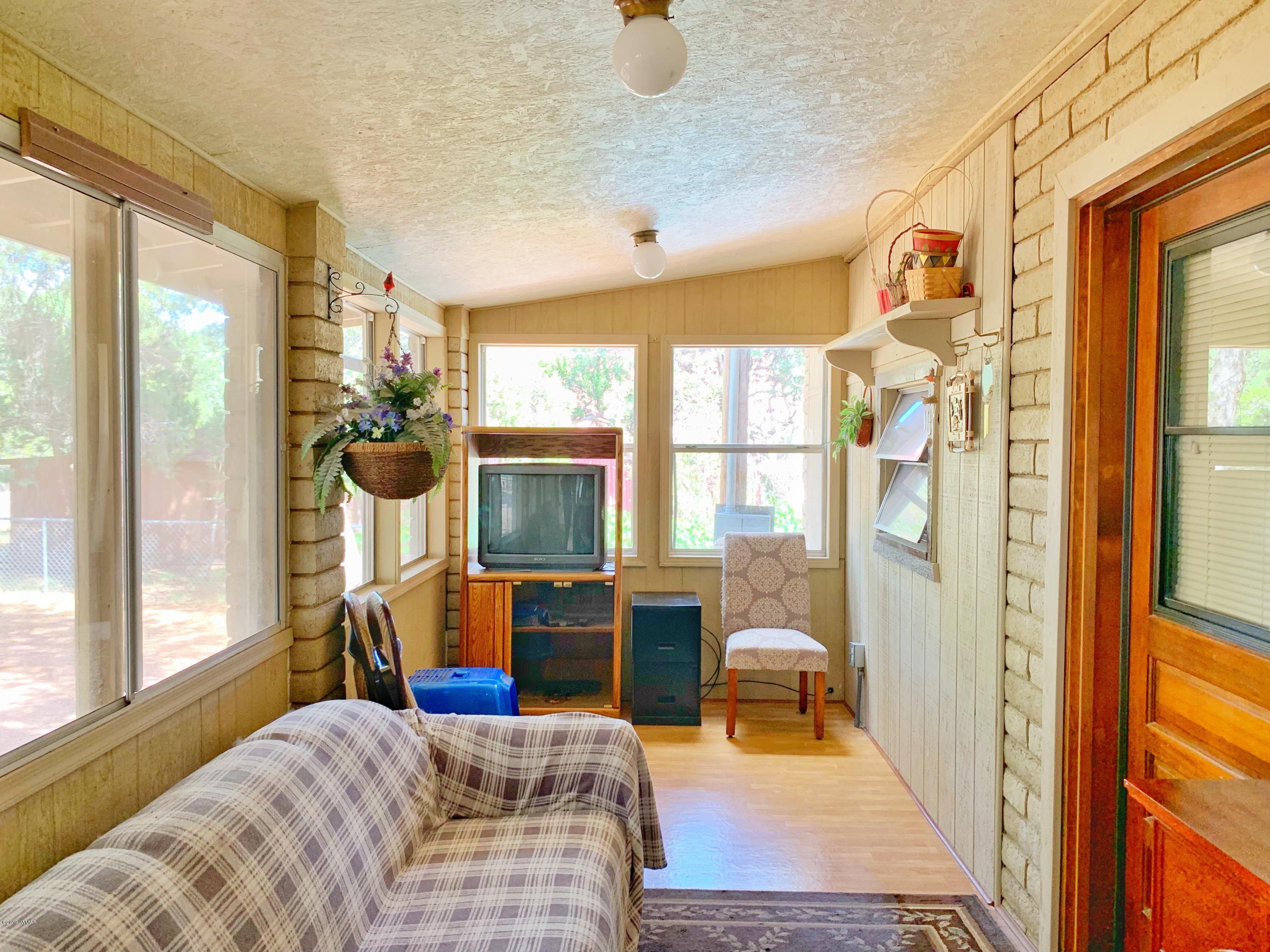 2128 Cottontail Road Overgaard, AZ 85933 - Photo 15 of 18 a bedroom with furniture and a window