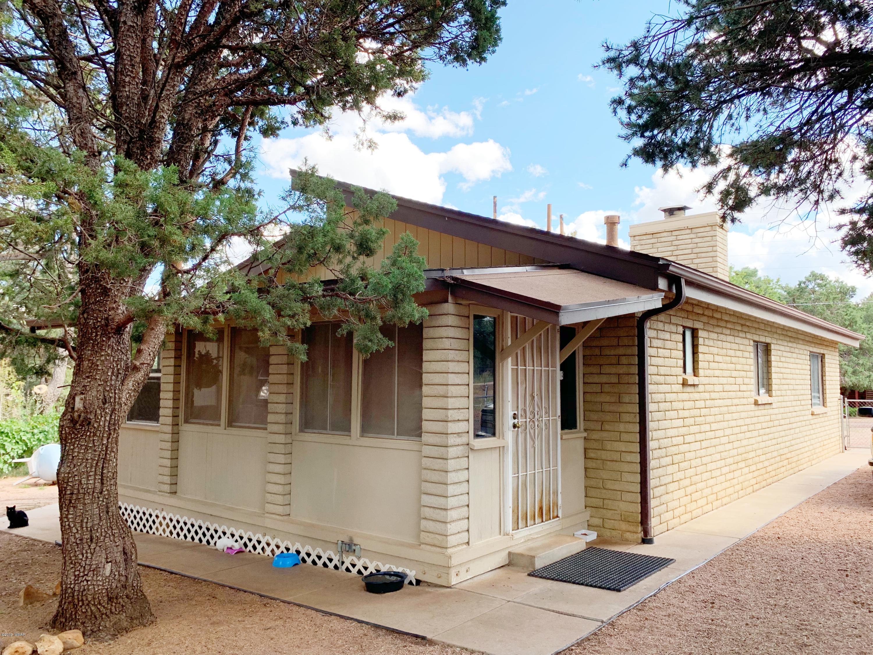 2128 Cottontail Road Overgaard, AZ 85933 - Photo 16 of 18 a front view of a house with a tree