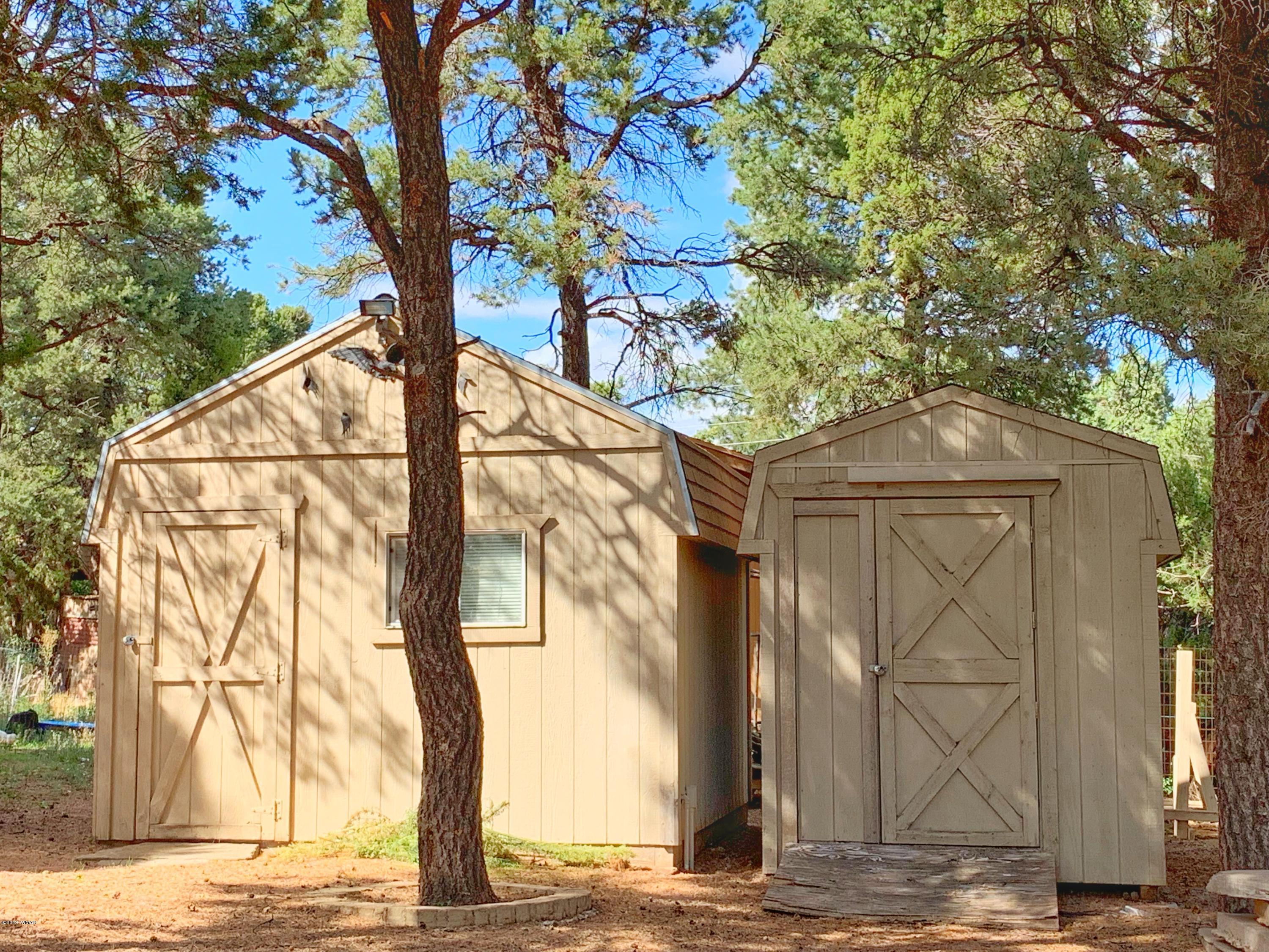 2128 Cottontail Road Overgaard, AZ 85933 - Photo 17 of 18 a front view of a house with trees