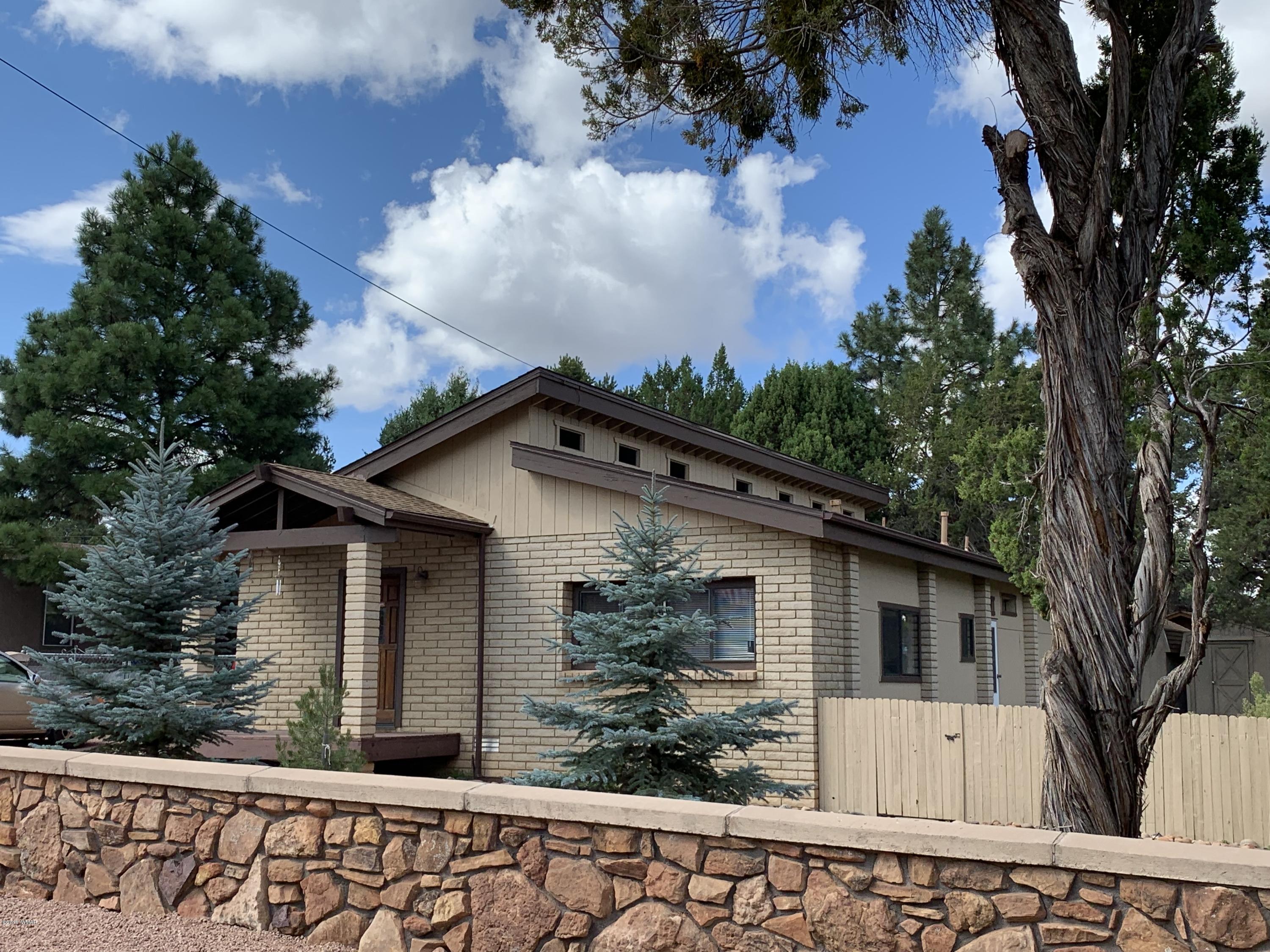 2128 Cottontail Road Overgaard, AZ 85933 - Photo 2 of 18 a front view of a house with garden