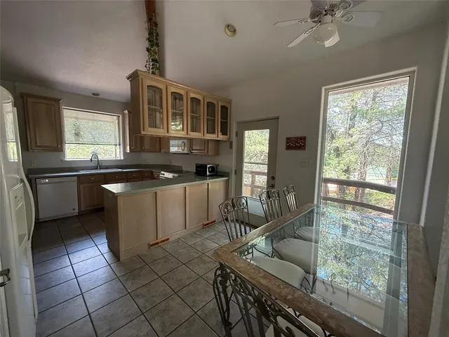 a kitchen with granite countertop cabinets stainless steel appliances a sink and a window