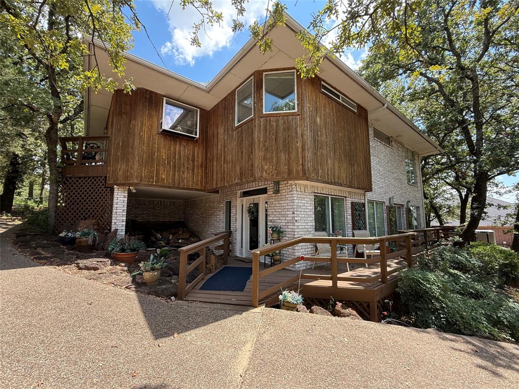104 Pawnee Trail Gainesville, TX 76240 - Photo 2 of 30 a front view of a house with a yard