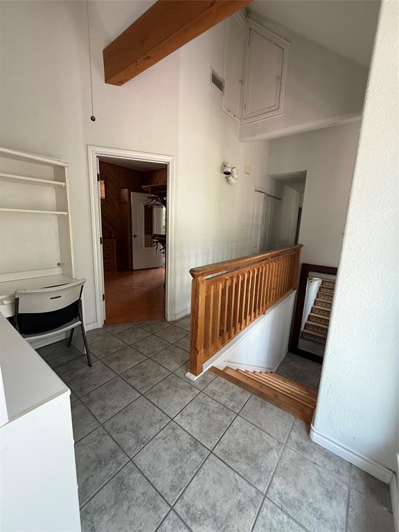 104 Pawnee Trail Gainesville, TX 76240 - Photo 24 of 30 a view of a hallway with stairs and wooden floor