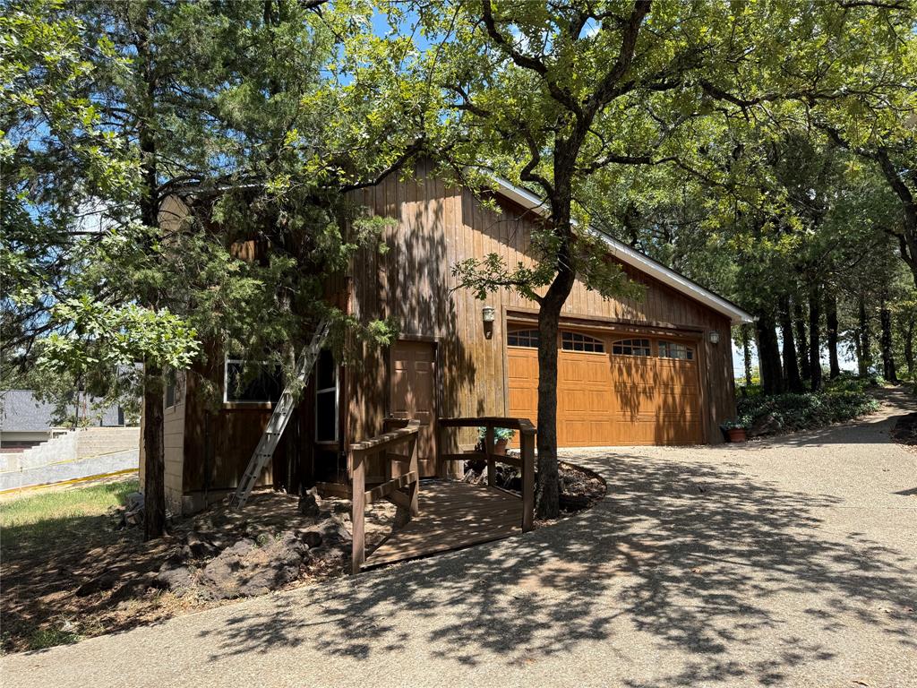 104 Pawnee Trail Gainesville, TX 76240 - Photo 3 of 30 a front view of a house with a yard