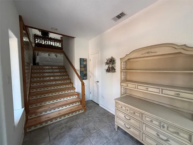 a spacious bedroom with a bed and couch