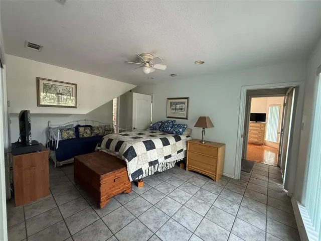 a bedroom with a bed and a television