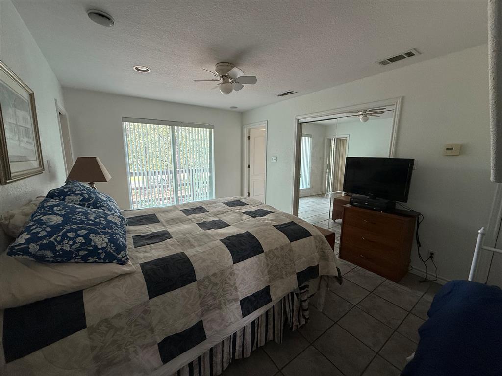 104 Pawnee Trail Gainesville, TX 76240 - Photo 6 of 30 a bedroom with a bed and a television