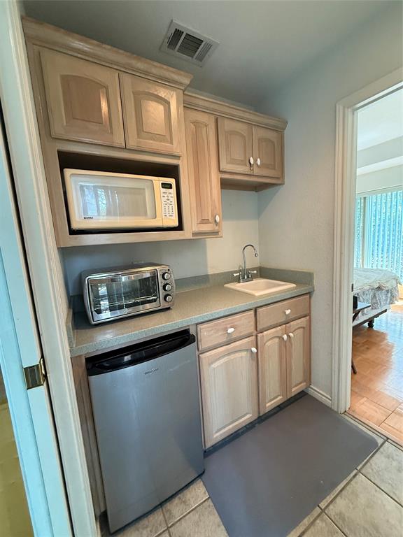 104 Pawnee Trail Gainesville, TX 76240 - Photo 10 of 30 a kitchen with stainless steel appliances granite countertop white cabinets stove a sink and dishwasher