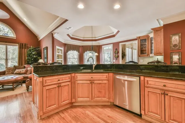 a spacious bedroom with a bed and a flat screen tv