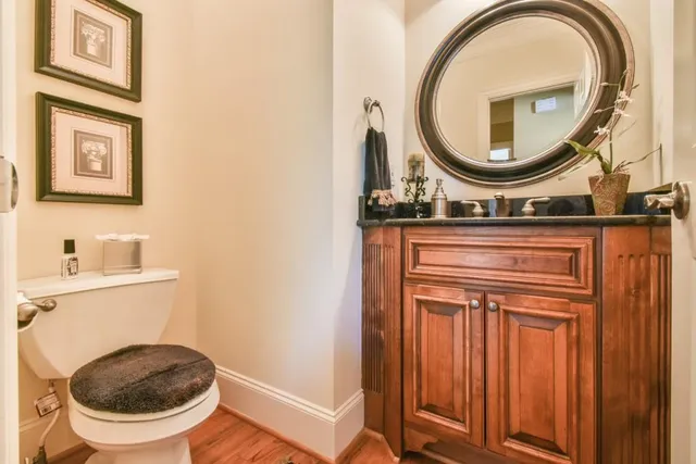 a large white bathroom with a sink mirror and a bathtub with double vanity