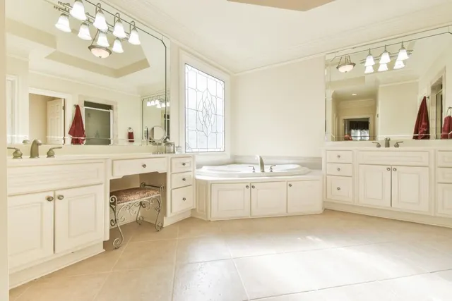 a bathroom with a granite countertop sink a mirror and shower