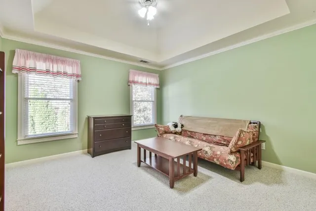 a living room with furniture a table and a large window