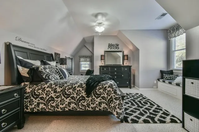 a bedroom with a bed and a chandelier